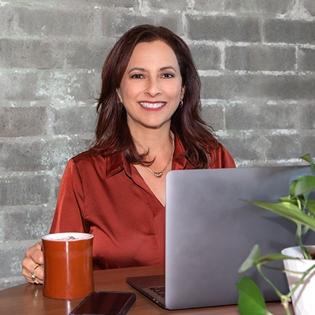 Julie Reuter sitting at computer